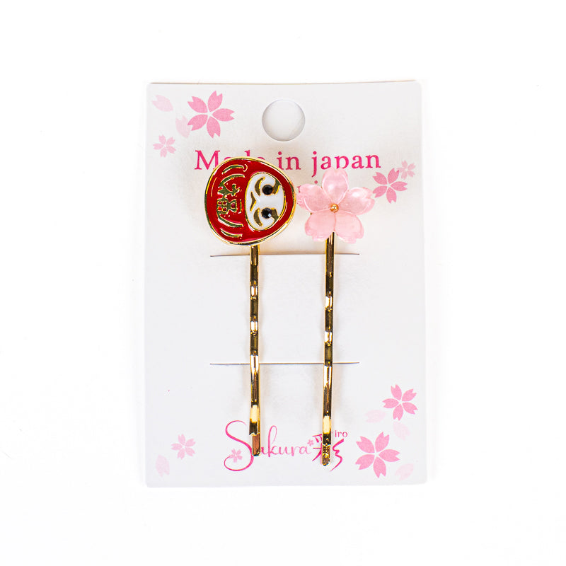 Japanska hårspännen med Daruma- och Sakura-motiv