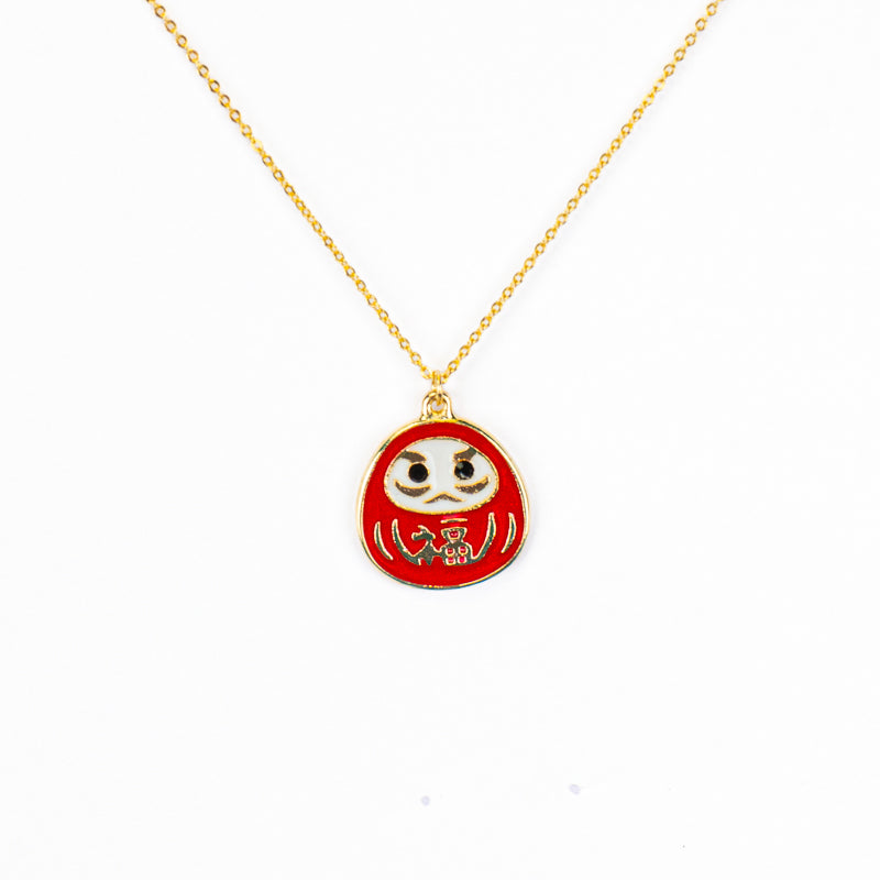 Japanskt halsband med rött och guldfärgat Daruma-hänge