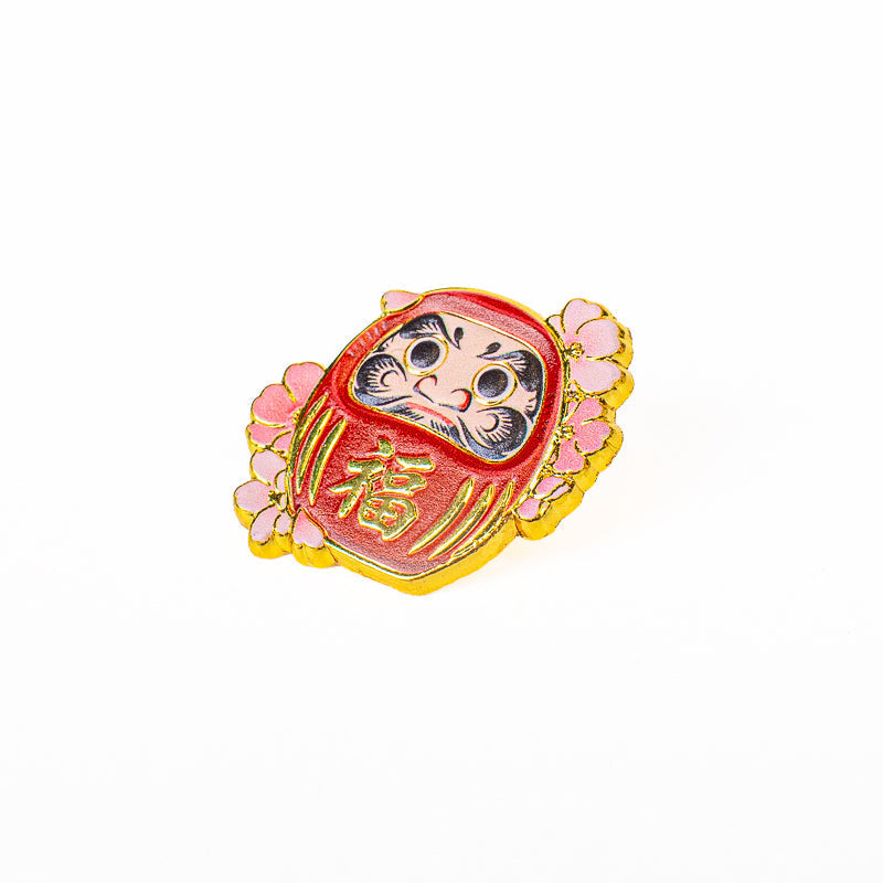 Japanska metallpins med Daruma och Sakura