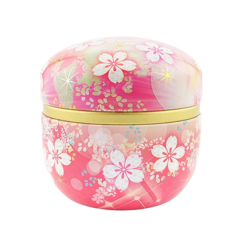 Teask i metall med rosa blommor